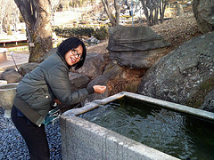 Me pretending to drink off a spring in Cheon An Bear Park, South Korea
